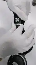 Firmly push the metal fastener upwards to permanently secure the headstrap-headband interface to the headstrap as shown. No adhesive is required.
