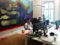 Mojang beim Arbeiten an ihren großartigen Werken (JahKob und Notch vor einem Minecraft-Gemälde mit Höhlen, in denen es Leitern, Wasser mit Tintenfischen und einen riesigen Schleim gibt)