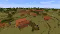 Ein Dorf am Rand einer Savanne