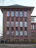 Fassade des Humboldt-Gymnasiums in Eichwalde mit themenbezogenem bildhauerischen Schmuck