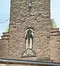 Christkönig-Relief mit Schlange und Greif