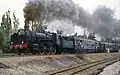 230 G 353 vor einem aus ehemaligen ETAT-Doppelstockwagen gebildeten Sonderzug bei Achères, 1982
