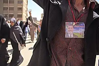 Mursi-Bild am Hals eines Demonstranten[150]