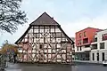 Ansicht des statisch gesicherten Fachwerkgebäudes von Süden, rechts das moderne Leinebogen-Quartier (2018)