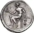 Didrachme. (ca. 425-415 v. Chr.), 24 mm. Männliche Figur. In seiner l. Hand hält er einen Schaber (strigilis) und ein Gefäß (aryballos). Mit der ausgestreckten r. Hand balanciert er eine Spindel. (Revers).[86]