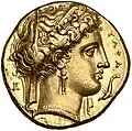 Stater. (um 320 v. Chr.), 18 mm. ΤΑΡΑ. Frauenkopf mit Diadem, Schleier, Perlenkette und Ohrring nach r. Vor dem Gesicht schwimmt ein kleiner Delphin abwärts. (Avers).[93]