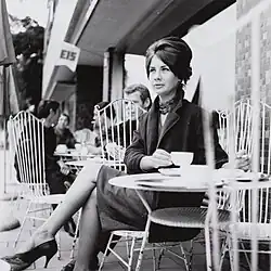Jane Seitz in den frühen 1960er Jahren vor einem Café sitzend