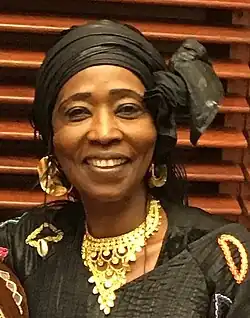 Fatoumata Coulibaly 2017. Eine afrikanische Frau mit Kopftuch und traditionellem Goldschmuck.