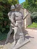 Heinrich V., mit der Urkunde des Wormsers Konkordates in der Hand, hört nicht mehr auf die Einflüsterungen des Kriegers.