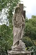 Grabstein des Kanonikers Giulielmus Weimer. Hohes Postament mit Johannes-Skulptur.