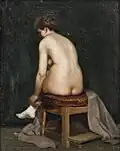 Frau beim Ankleiden auf einem Hocker