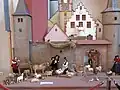 Fränkische Krippe: Figuren in Fränkischer Tracht vor der Stadtmauer von Karlstadt mit dem Maintor