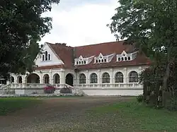 Exterior of a long, white colonial-style building