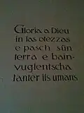 Wandinschrift auf Vallader: Ehre sei Gott in der Höhe und Friede auf Erden und unter den Menschen ein Wohlwollen