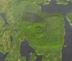 Eine von Wasser umegebene Landmasse mit einem kreisförmigen Objekt in der Mitte