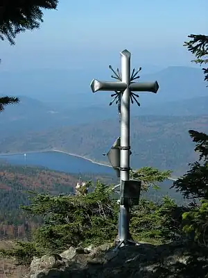 Gipfelkreuz des Kleinen Rachel mit Blick auf die Trinkwassertalsperre Frauenau