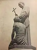 Statue eines Priesters in Tilburg (Niederlande), der einen Leprakranken durch Handauflegung missionieren und damit heilen will. Um 1950
