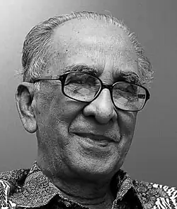 Habibur Rahman. 2011. Porträt eines älteren Mannes mit hoher Stirn, dichte Augenbrauen und Brille.