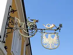 Nasenschild des Hotels Adler mit Posthorn (früher Poststation) in Schwetzingen