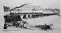 Die erste Nordbahnbrücke über die noch nicht regulierte Donau mit dem Eröffnungszug am 6.&nbsp;Jänner 1838