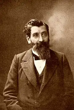 Dieses Foto zeigt den französischen Sozialisten Paul Brousse, Anführer der Bewegung Possibilismus in schwarzweiß als Porträtdarstellung von vorn. Es entstand um 1900.