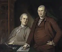 Links sieht man den jüngeren Gouverneur Morris auf einem Stuhl sitzend. Er trägt einen grauen Anzug und ein weißes Halstuch. Rechts von ihm steht Robert Morris, der einen braunen Anzug und ein weißes Halstuch trägt. Vor Gouverneur Morris und links von Robert Morris steht ein Tisch mit eine Dokument und einer Feder in einem Tintenfass.