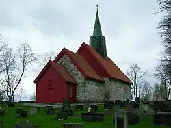 Foto einer steinernen Kirche mit Friedhof im Vordergrund