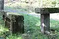 Steinrast im Kottenheimer Wald bestehend aus einer Hochbank und einer dreifüßigen Sitzbank.