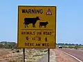 Dreisprachiges Warnschild nahe Coober Pedy