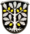 Wappen von Okriftel (Hessen) mit Laub, Eicheln und Wurzel