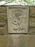 Schlussstein über einem Torbogen mit den Insignien von König Georg&nbsp;III.