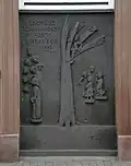 Die Zachäustafel, ein Basaltrelief an der Straßenfront des Marmagener Pfarrhaus an der Kölner Straße, ist ein frühes Werk des rheinischen Bildhauers Titus Reinarz. Es stellt im Stil einer Eifeler-Takenplatte die biblische Szene aus dem Lukas-Evangelium dar, in der der kleinwüchsige Zöllner Zachäus auf einen Baum klettert, um den vorbei ziehenden Jesus zu sehen (Lk 19,1–11).