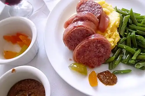 Zampone in Scheiben geschnitten mit Kartoffelpüree und Bohnen